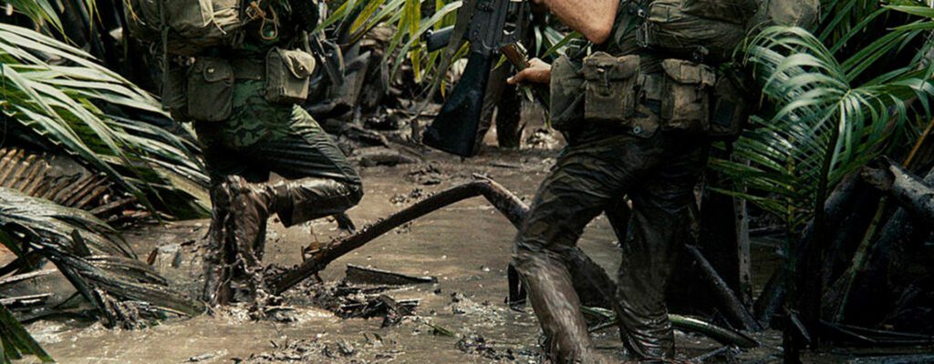 A group of men in the mud with guns.